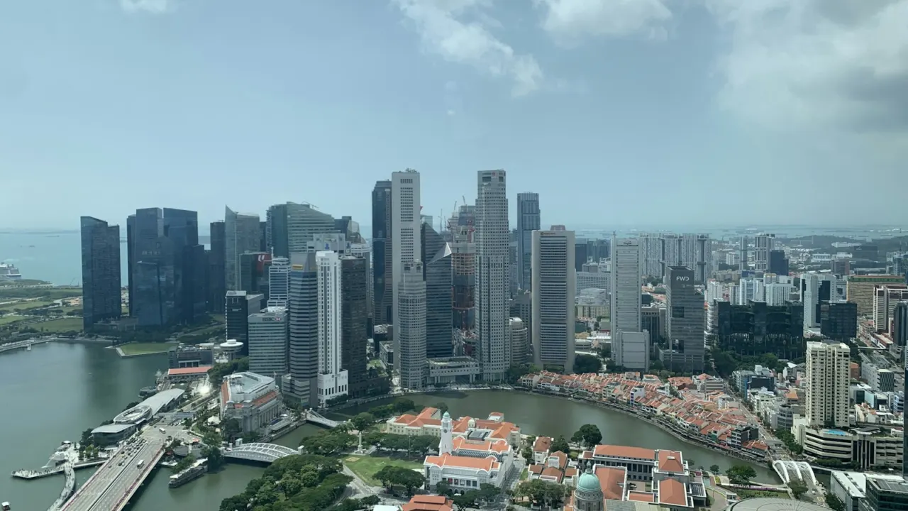 Aerial view of Singapore’s city centre with office towers, low-rise shophouse streets and the harbour beyond