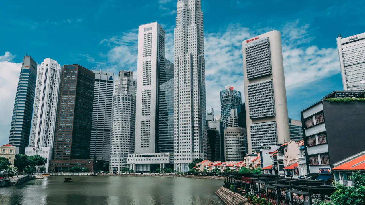 Singapore River shophouses in front of the tall office towers of the Central Business District