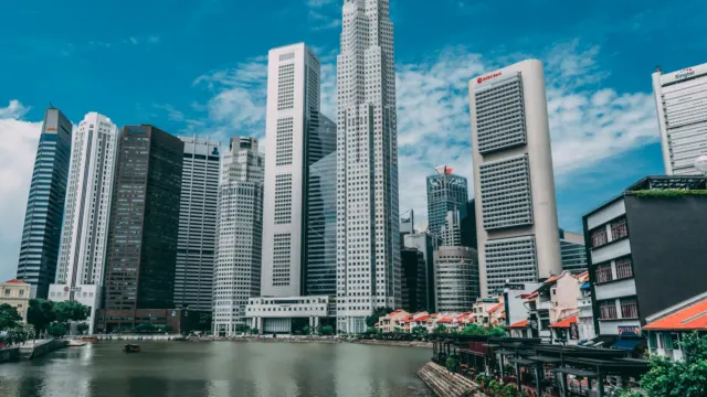 Singapore River shophouses in front of the tall office towers of the Central Business District