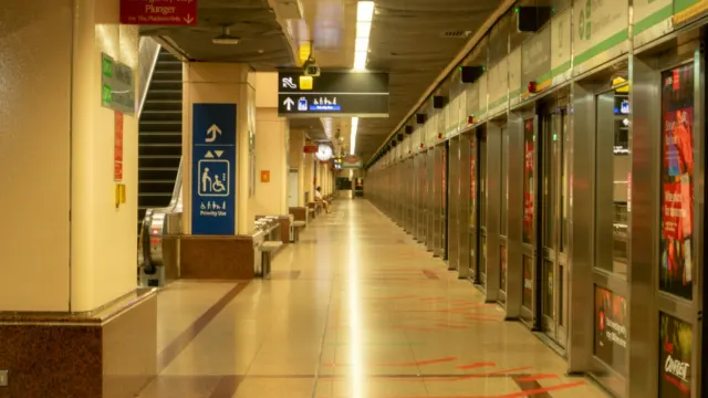An empty underground MRT platform with a long row of closed platform screen doors