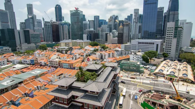 Aerial view of Singapore shophouses, a construction site and office towers, showing how city land is redeveloped