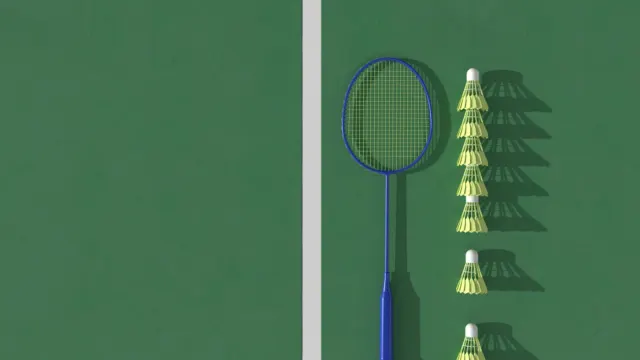 A badminton racket and a row of shuttlecocks laid out on a green court