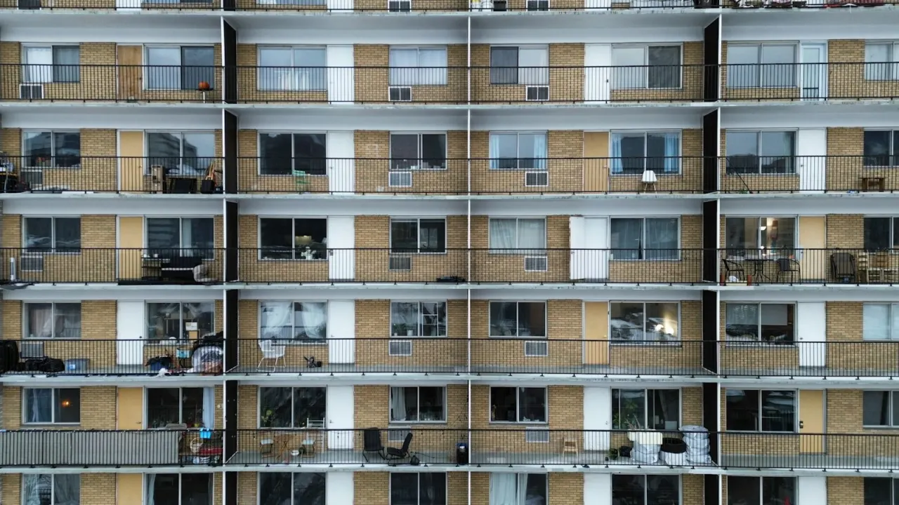 Facade of a multi-storey apartment building with rows of balconies