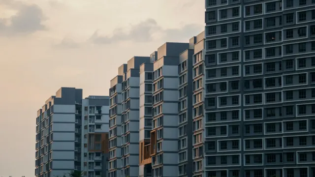Row of high-rise residential blocks in Singapore at dusk