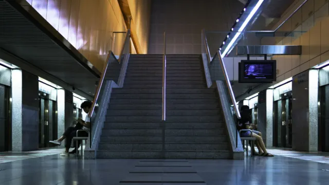 Staircase and quiet platform level inside an underground MRT station in Singapore