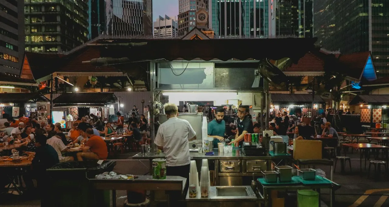 Customers queuing at a drinks stall in a busy Singapore hawker centre