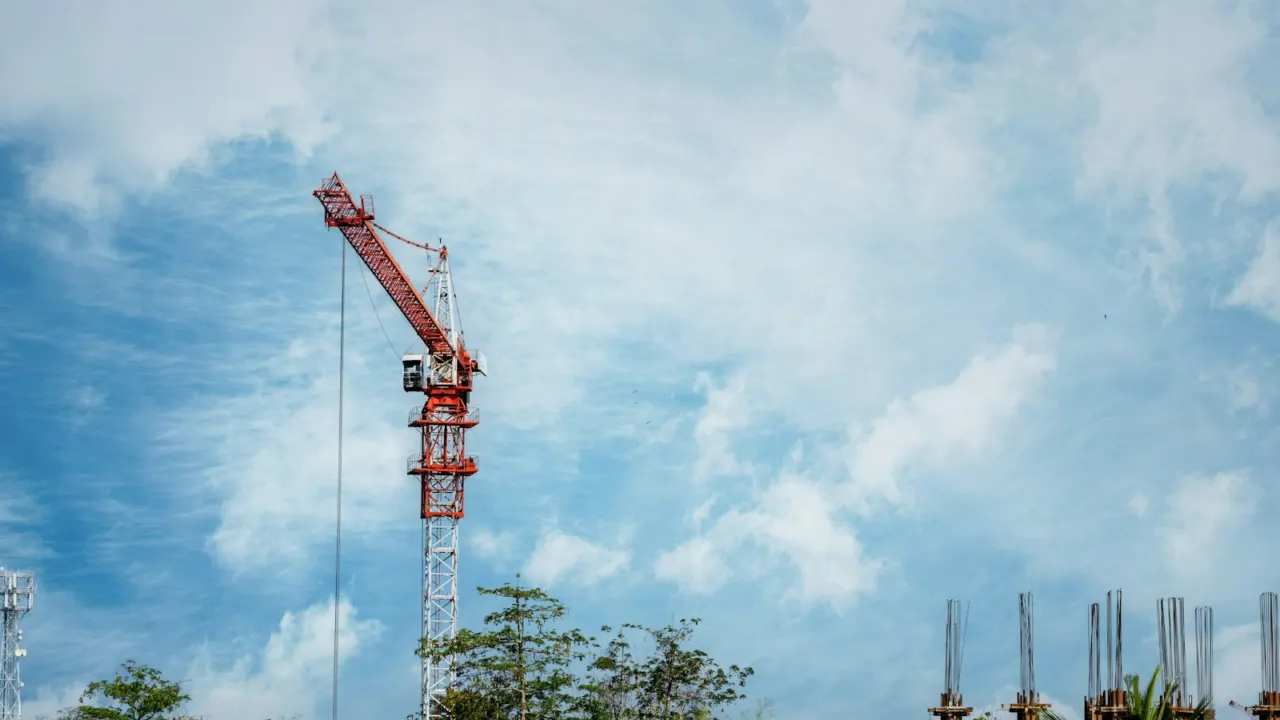Construction crane against a cloudy blue sky