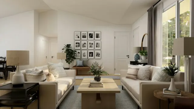 Furnished living room with a white sofa and potted plant, styled like a model unit