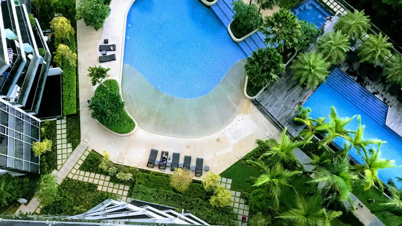 Aerial view of condominium swimming pools and landscaping between residential blocks