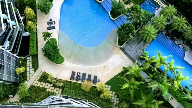 Aerial view of condominium swimming pools and landscaping between residential blocks