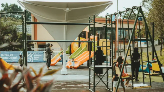 Children climbing and sliding on a brightly coloured outdoor playground
